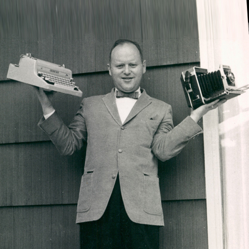 Martin Elkort holding typewriter and camera